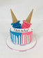 Two-toned ice cream cake with blue and pink colors and ice cream cones on top.
