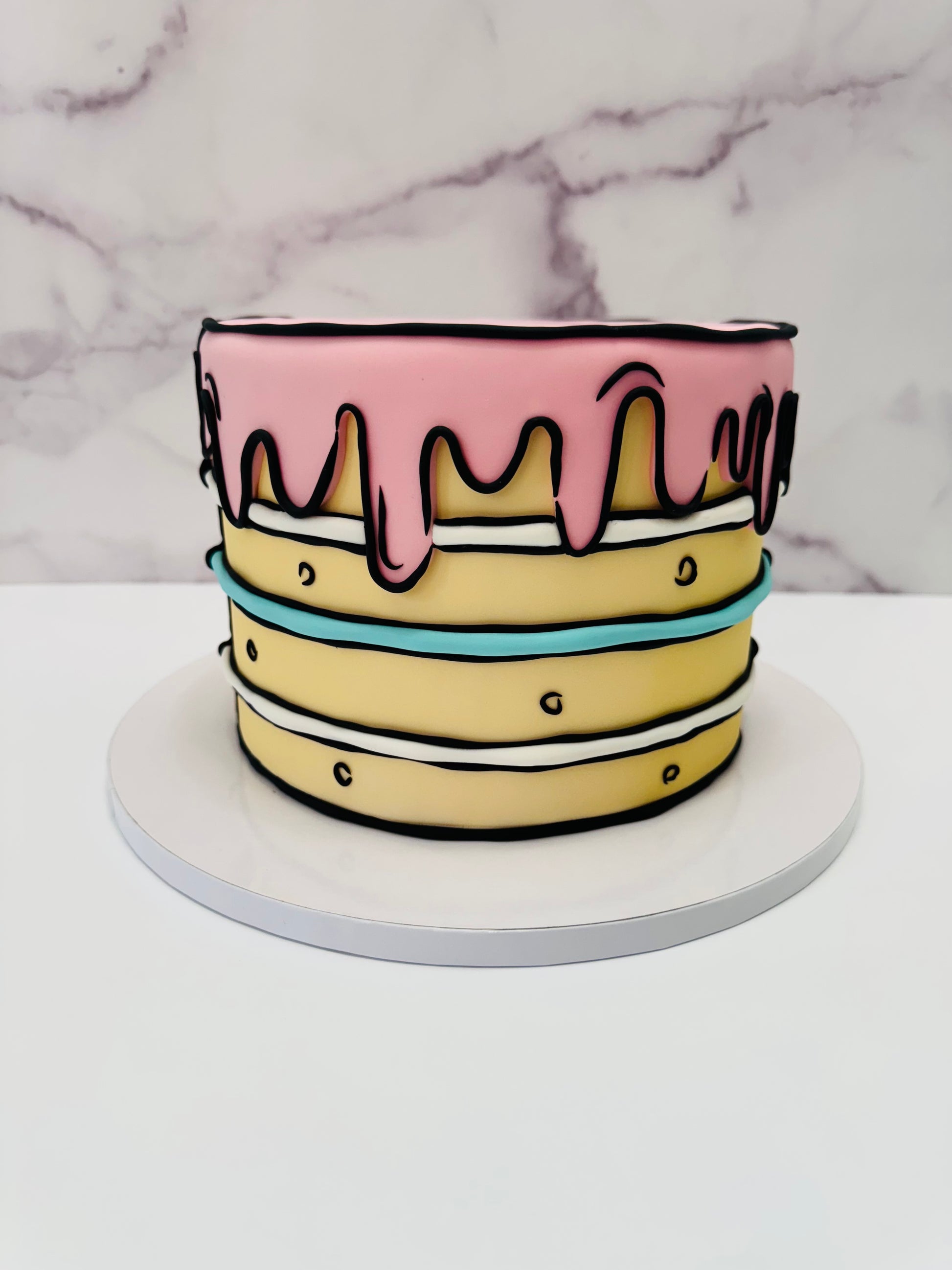 Colorful cake with pink icing on a marble background