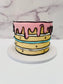 Colorful cake with pink icing on a marble background