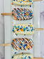 OKC Thunder Basketball Cakesicles with white chocolate drizzle and colorful sprinkles on wooden sticks.