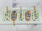 Five decorated OKC Thunder Basketball Cakesicles on sticks with colorful toppings on a white plate.