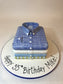Cake shaped like a blue checkered shirt with 'Happy 35th Birthday Mike!' text on a white background