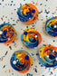 Cupcakes with colorful swirl frosting and sprinkles on a light background