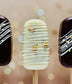 Three ice cream cakesicles with decorative patterns on a blurred background
