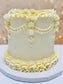 White cake with decorative ruffles on a blurred background